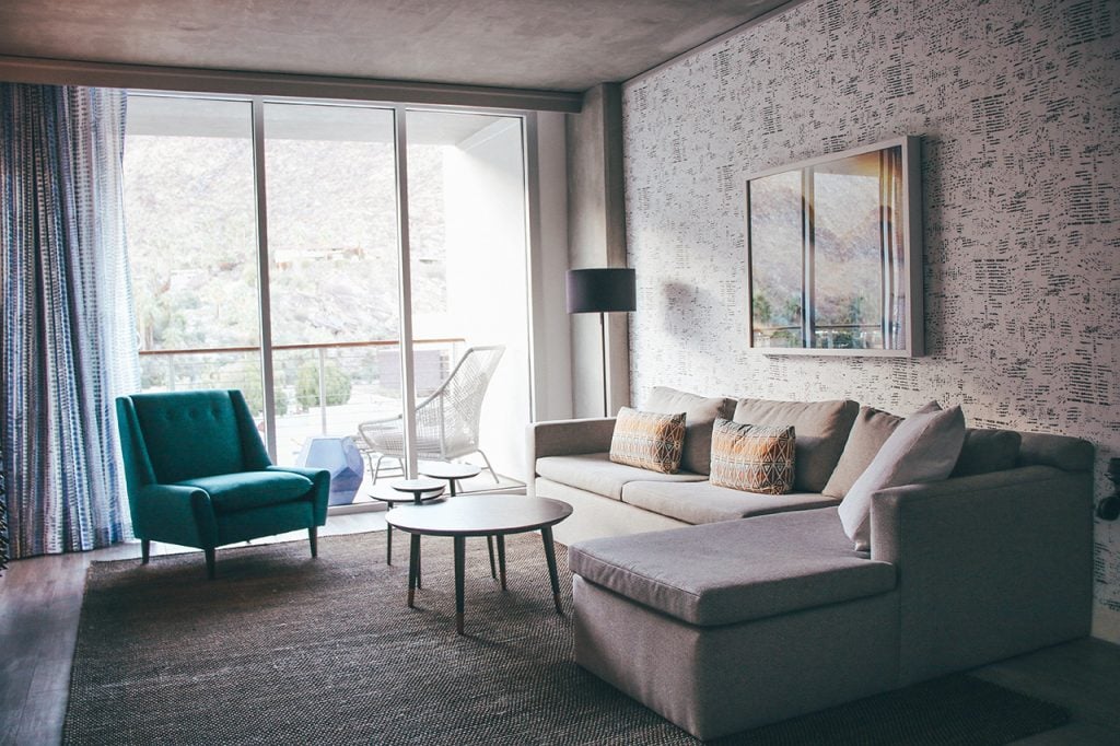 living room area with ceiling to floor windows at The Kimpton Palm Springs